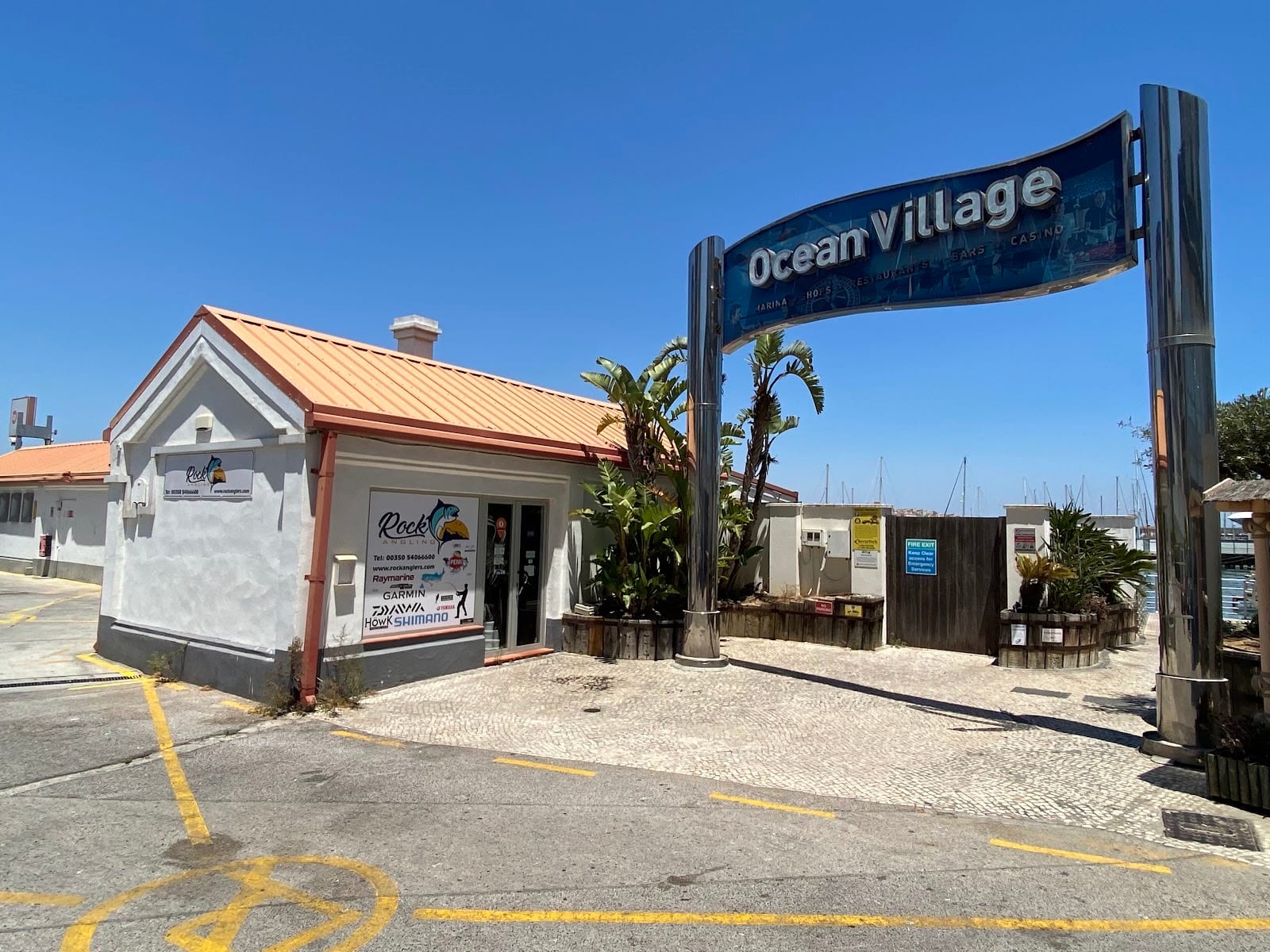 The Rock Angling unit, white with an orange roof, beside the Ocean Village arch sign